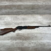 Ammunition rifle on a wooden surface at Checkpoint Charlie, Berlin, showcasing Cold War history and firearm display.