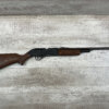 Firearm replica of a rifle or shotgun laying on a wooden surface, used for display or decoration at Checkpoint Charlie's, a famous Berlin historical site and tourist attraction.