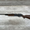 Vintage air rifle with wooden stock on light wooden background.