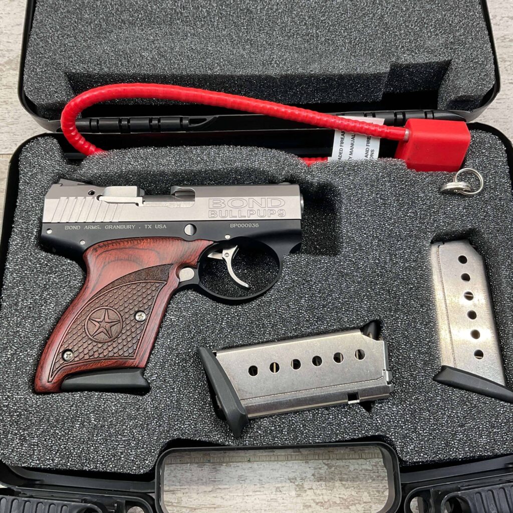 Gun replica with wooden grip, silver slide, and empty magazines in foam-padded case, themed for collectibles or cosplay, not actual firearm.