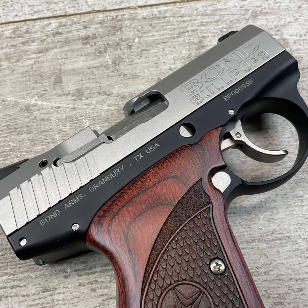 Bulletproof Glock pistol with wood handleâ€”firearm detail from Checkpoint Charlie's historic Berlin Wall site.
