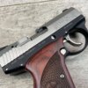 Bulletproof Glock pistol with wood handleâ€”firearm detail from Checkpoint Charlie's historic Berlin Wall site.