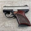 9mm pistol with wooden grip and "BOND" engraving, placed on a wooden surface, symbolizing American firearm craftsmanship and collectibles.